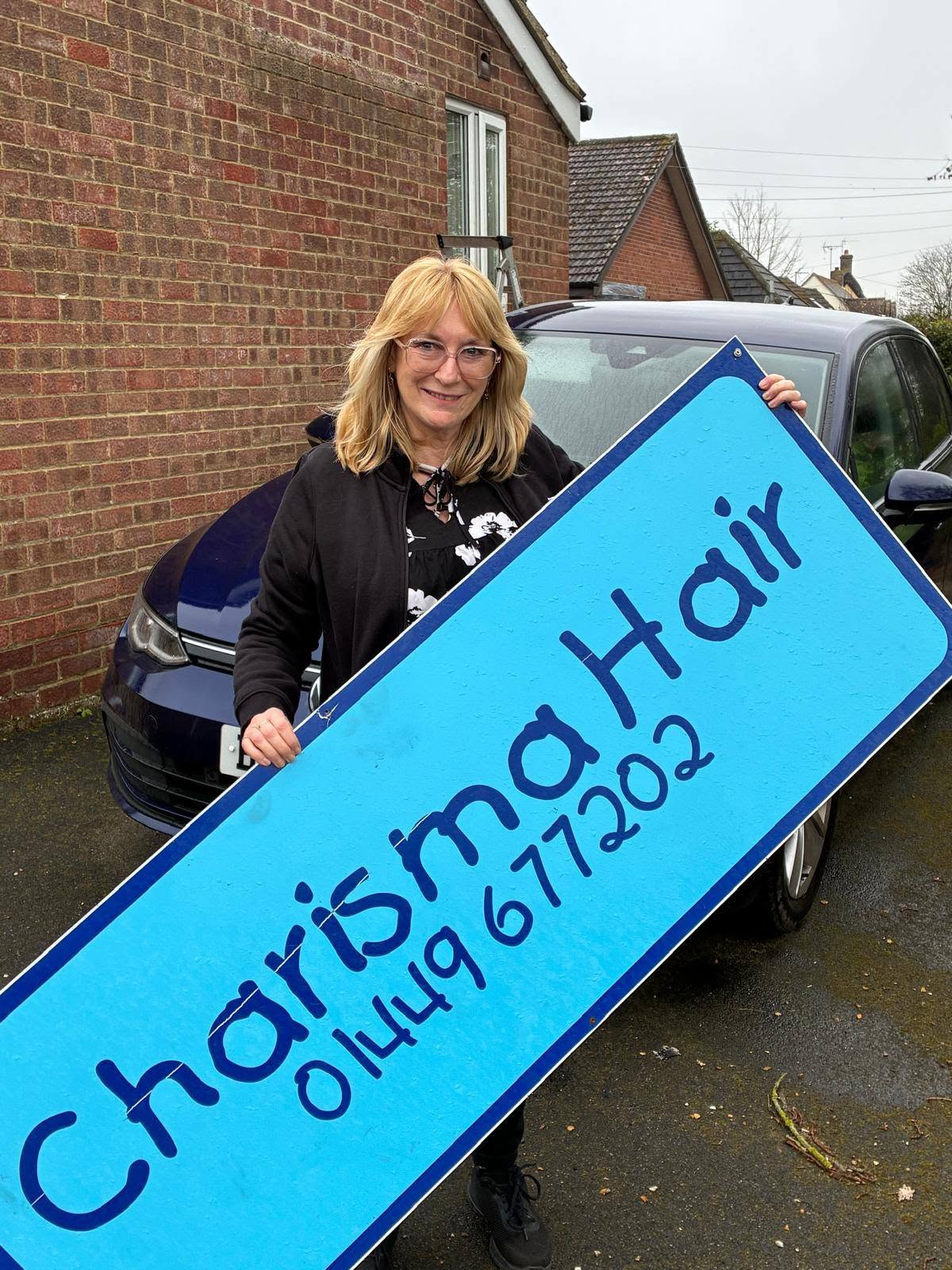 The Charisma Hair salon sign